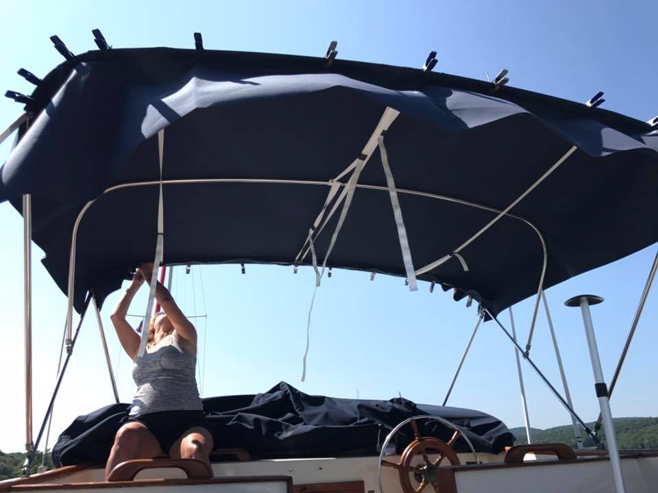 A canvas-covered boat moored at Rondout Yacht Basin.